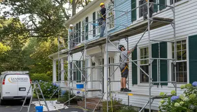 Painters working on a Beverly, MA home exterior for professional painting services